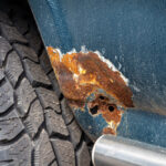 Part,Of,A,Blue,Car,With,Rust,And,A,Holes