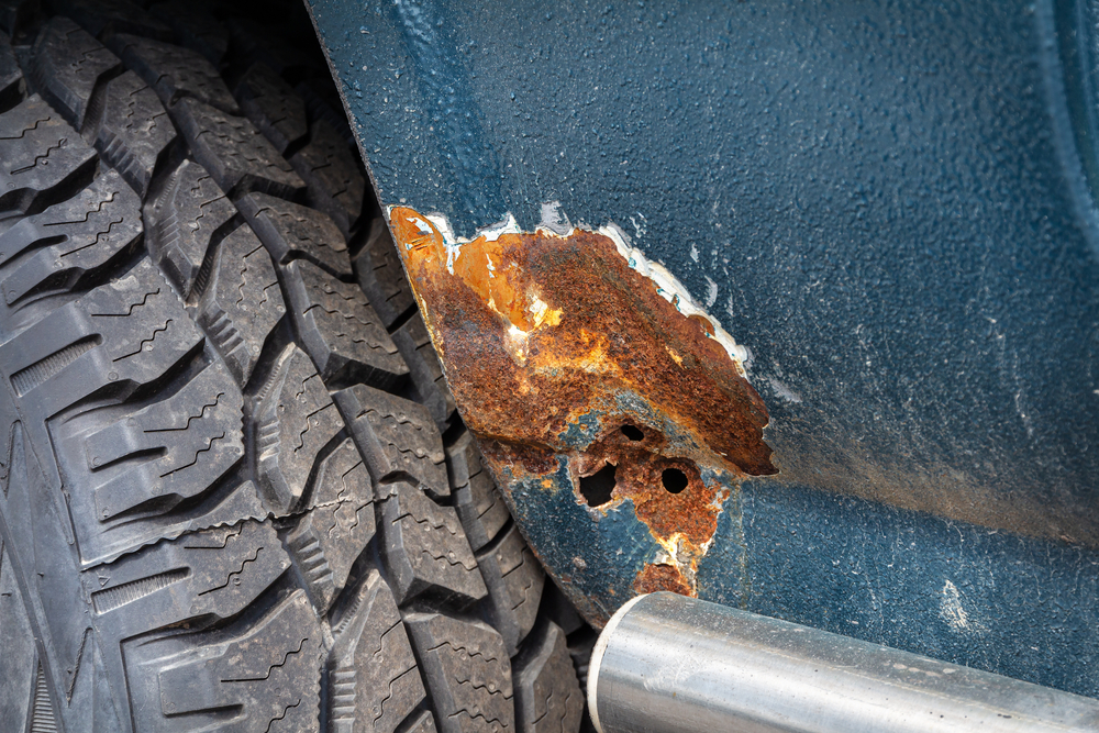 Part,Of,A,Blue,Car,With,Rust,And,A,Holes